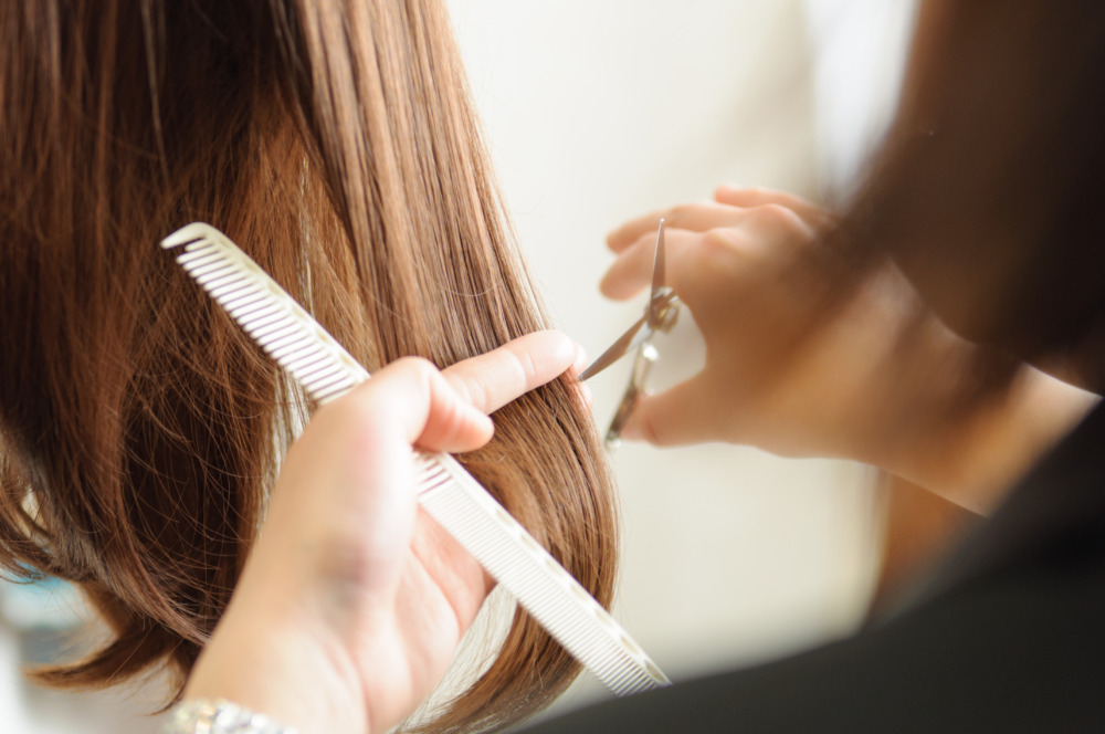 髪を切るヘアスタイリスト　美容室