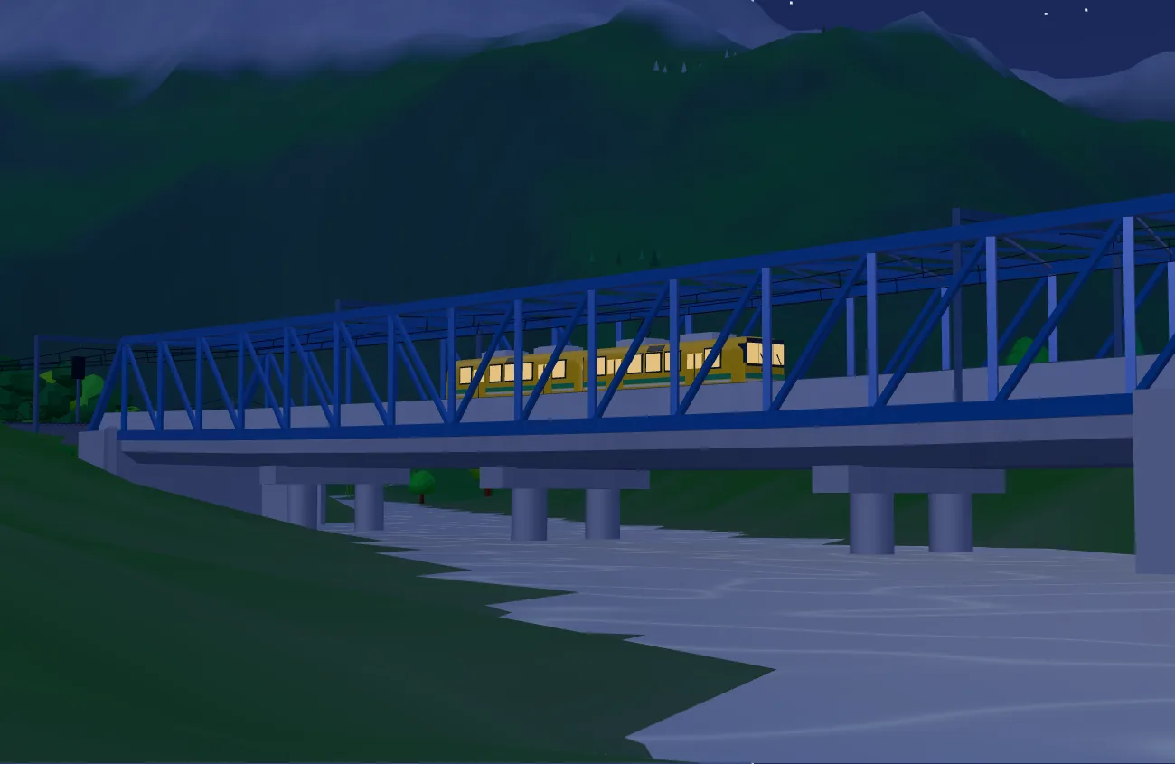 夜。暗い山を背に、窓に明かりのともった電車が鉄橋を渡っている